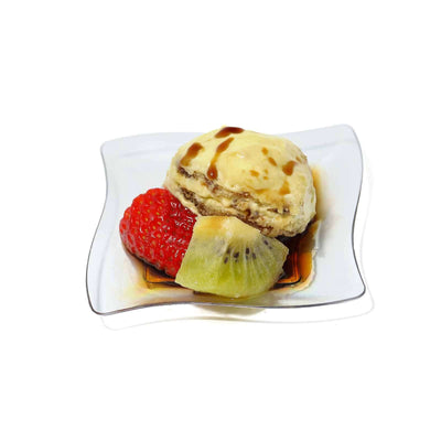 Dessert with macaron, ice cream, and fresh fruit on a plate