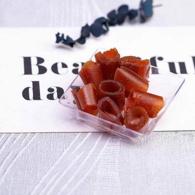 Gummy candy in a clear container on a textured surface