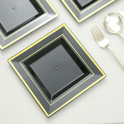 Black square plate with gold trim, styled with cutlery.