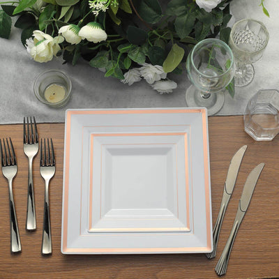 Elegant rose gold trimmed square plate set on a beautifully arranged dining table.