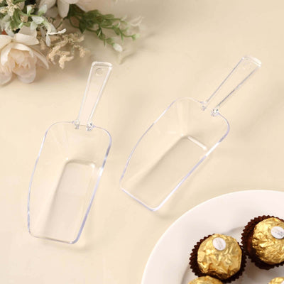 Clear plastic scoops for serving, ideal for candy or dry goods.