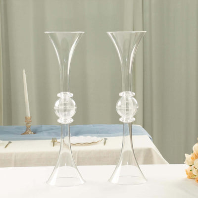 Elegant glass candle holders on a table with soft decor.