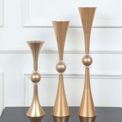 Set of three elegant gold vases in varying heights