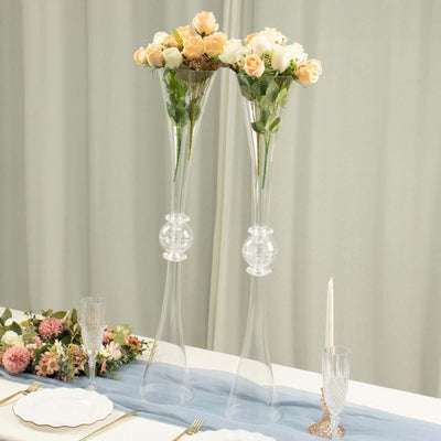 Elegant glass flower vases with roses for wedding or event decor.