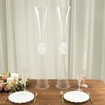 Elegant clear glass vases on a beautifully set dining table.