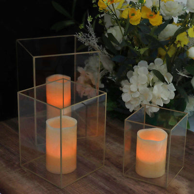 Decorative candle holders with glowing candles and floral arrangement.