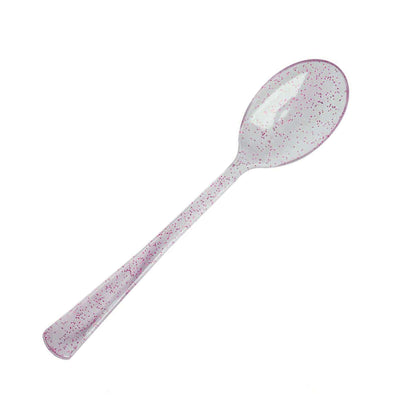 Pink speckled serving spoon on a white background