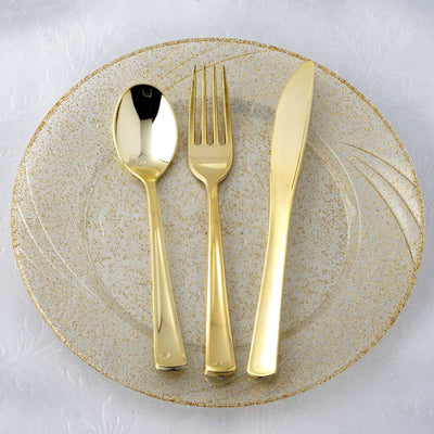 Gold cutlery set on a decorative plate.