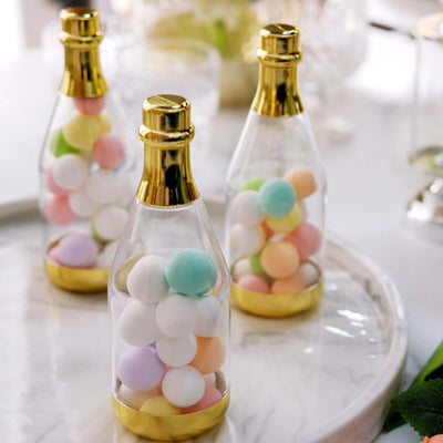 Colorful candy-filled bottles with gold accents on a white background