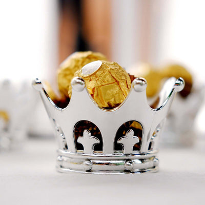 Silver crown-shaped holder with chocolate truffles inside.