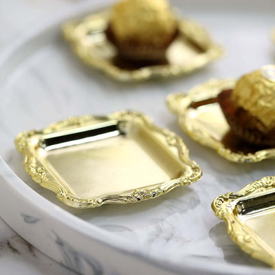 Elegant gold square trays on a marble serving platter