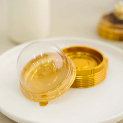 Golden dessert dome and base on a white plate.