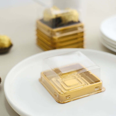 Gold dessert packaging on a white plate with background items.