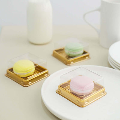 Colorful macarons in clear boxes on a neutral table setting.