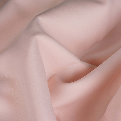 Soft pink fabric texture with gentle folds and drapes.