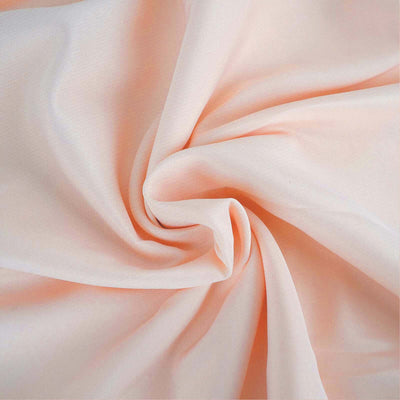 Soft peach fabric with gentle draping and texture.