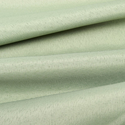 Textured light green fabric in folds, showcasing its softness and sheen.
