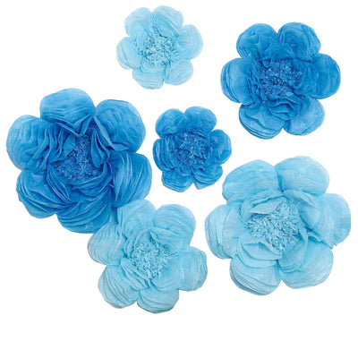 Blue paper flowers in various sizes on a white background.