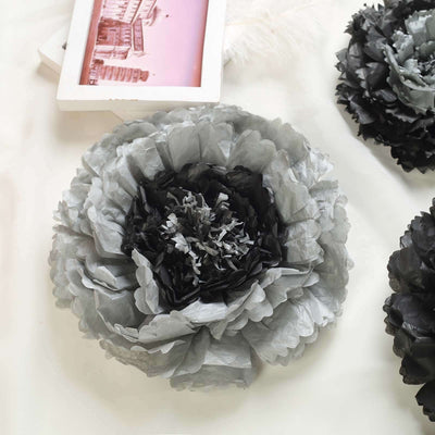 Gray tissue paper flower decoration on a plain background.