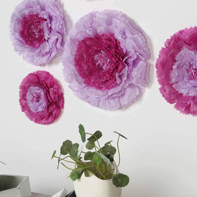 Colorful paper flowers in lavender and pink mounted on a white wall.