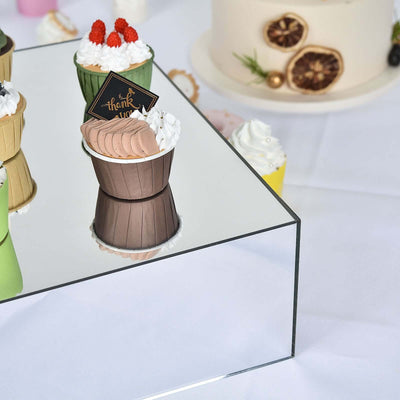 Deliciously decorated cupcakes on a reflective surface, perfect for celebrations.