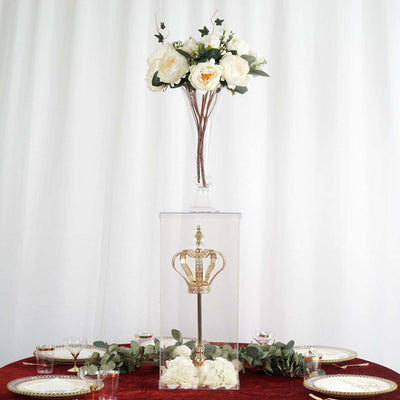 Elegant crown display with floral arrangement on a table setting.