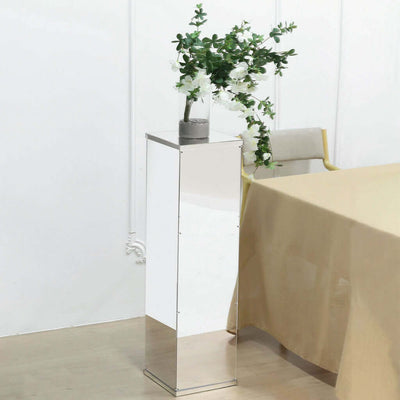 Modern mirrored plant stand with flowers, elegant design for home decor.