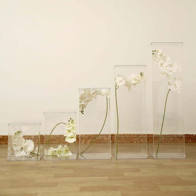Clear acrylic display boxes with white orchids arranged in ascending order.