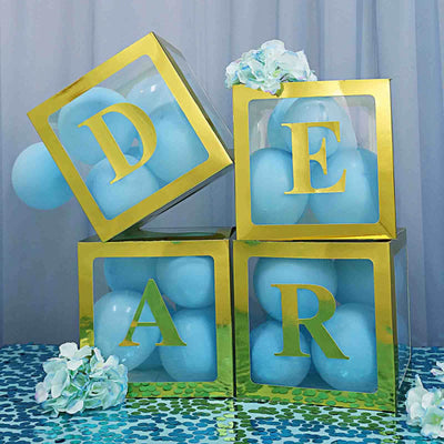 Decorative gold and blue balloon display spelling "DEAR" on a festive table.