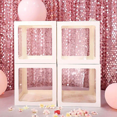 Decorative display boxes on a pink sequin backdrop with balloons.