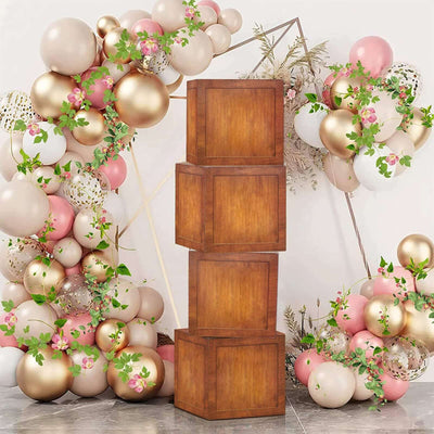 Wooden decorative boxes stacked with a floral and balloon backdrop.