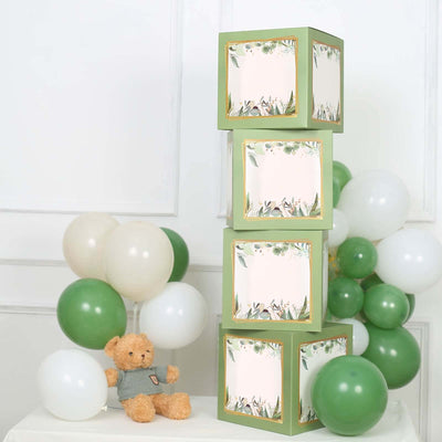 Decorative green boxes stacked with balloons and a teddy bear in a festive setting.