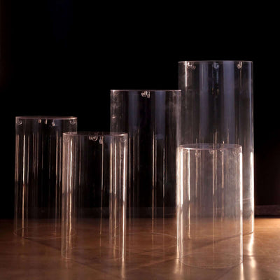 Clear acrylic display risers in various heights against a dark background.