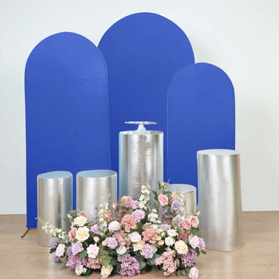 Silver and blue display pedestals with floral arrangement in studio setting.