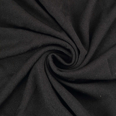 Black fabric with a smooth texture, swirling in a circular pattern.