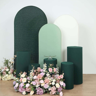Colorful display of pedestals with floral arrangements in a studio setting.