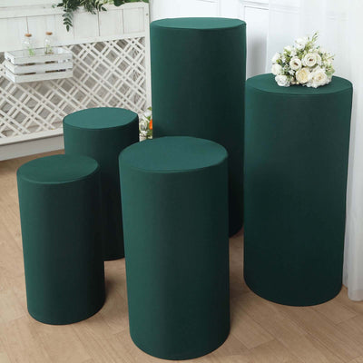 Set of five green display pedestals for events and decor.