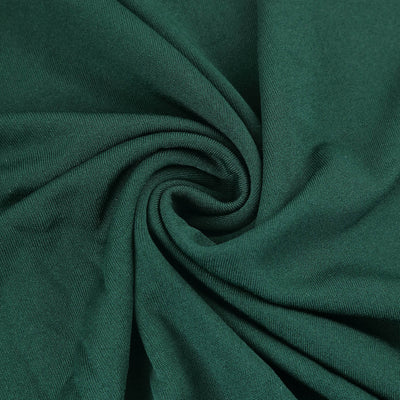 Dark green fabric in a swirl pattern showcasing its texture and richness.
