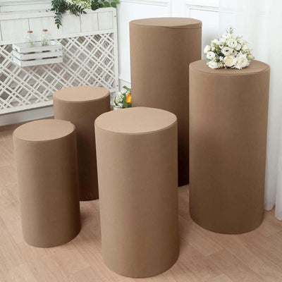 Set of five round cardboard display pedestals in varying heights