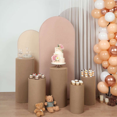 Decorative dessert display with cake, cupcakes, and balloons for a celebration.