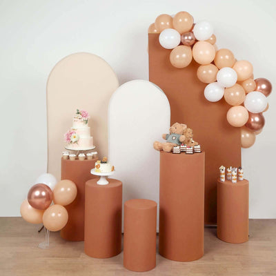 Decorative display with balloons, cake, and teddy bear for a celebration.
