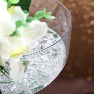 Clear glass bowl with white flowers and decorative crystals.