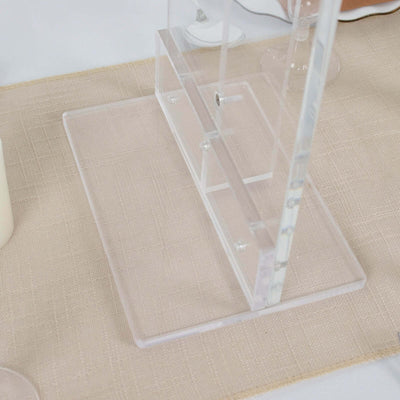 Acrylic stand base on a table setting with a beige tablecloth.