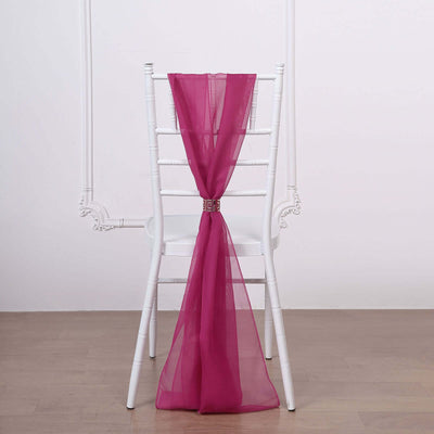 Magenta sheer chair sash tied in a bow on a white chiavari chair
