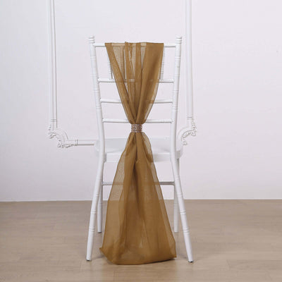 Brown sheer chair sash tied on a white chair in a studio setting.