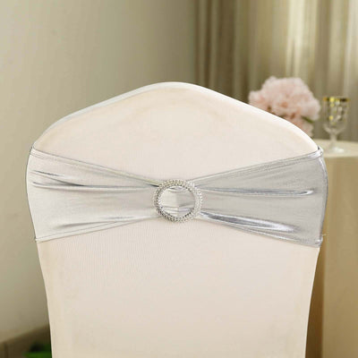 Silver chair sash with rhinestone buckle for elegant event decor.