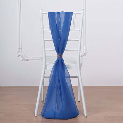 Blue sheer chair sash tied with a decorative buckle on a white chair.