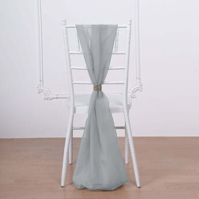 Gray chiffon chair sash tied on a white chiavari chair.