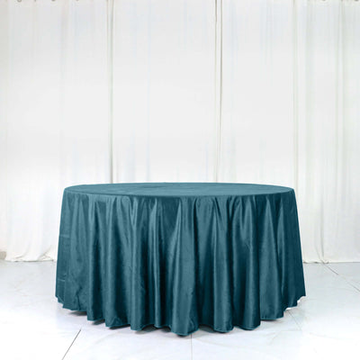 Round teal tablecloth on a white backdrop