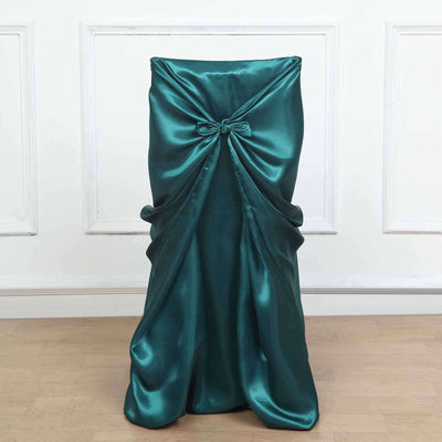 Teal satin chair cover with bow detail on a plain backdrop.